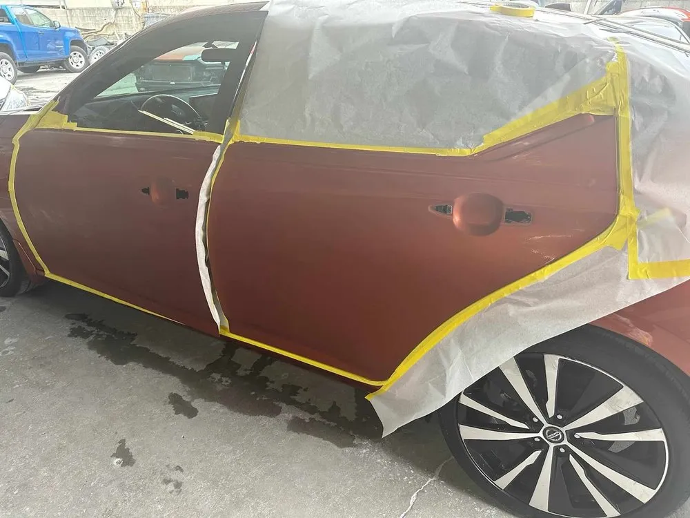 Car doors masked with tape and paper, primed and ready for new paint