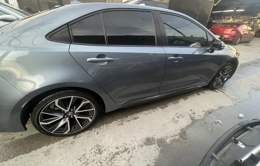 Gray Toyota Corolla parked outside the On Point Auto Body shop on Hazeltine Avenue